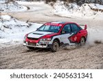 Small photo of Tukums, Latvia - January. 7. 2023: Youngsters practice safe driving on a winter track with the Mitsubishi Lancer Evo street sports car