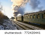 Beautiful old steam train with wagons running on rails at sunset. Excursions for children and parents on festive special days. Czech Republic Europe.