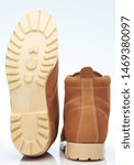 Small photo of Brown off road shoes bottom and back view isolated