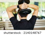 Small photo of Active Asian sportsman doing a weight exercise in a gym - fitness by lifting up a dumbbell, man lifting up or holding a heavy dumbbell in Overhead Tricep Extension position. Bodybuilding workout.