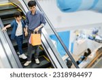 Small photo of Happy cheerful Asian man and son walking tougher in the department or grocery store, man taking his son to shop a clothing and toys in the department store or mall.