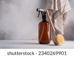 Single amber brown spray bottle and dish brush. Kitchen cleaning products for eco friendly and sustainable life style. 