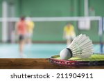 Badminton courts with players competing.