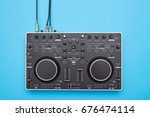 Flat lay of well-designed DJ panel on blue background