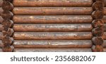 Small photo of A log wall construction with a swedish cope log profile. Dirty and heavily cracked brown wall of a blockhouse as a natural rural background