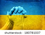 Mature Hands in Pray Gesture on the Dirty National flag of Ukraine