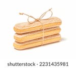 Stack of italian biscuits or ladyfingers savoiardi cookies tied with a rope, isolated on white background 