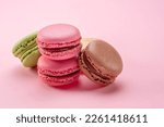 Colorful french macarons isolated on pink background.