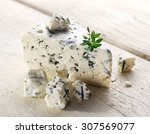  Slices of Danish Blue cheese on an old wooden table.