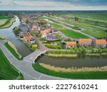 Aerial scenic view of typical Dutch village surrounded with polders and fields, North Holland, the Netherlands