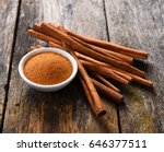 Cinnamon sticks and cinnamon powder on wood