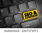 Seo and Adwords text button on keyboard, business concept background