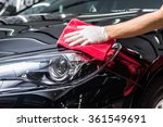 Car detailing series : Worker cleaning black car