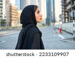Side view portrait of beautiful Arab young woman wearing traditional arabic clothing.