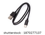 Black USB cable with plugs type A and type C at the edges on a white background 