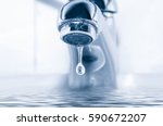 Faucet and water drop close up