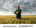 Portrait of farmer standing in wheat field.