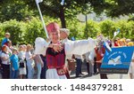 Small photo of Tallinn, Estonia - JUL 06, 2019: An aged woman is dancing on parade during Estonian Song and Dance Festival