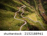 Curvy mountain road on the green part of Tenerife island, Spain. Top aerial view