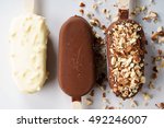 vanilla popsicles coat with chocolate and top with almond.