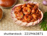 Spicy hot Prawn roast or shrimp fry. Masala fish curry served in sea shell. Indian food Asian cuisine. Kerala fish curry also popular in South Indian Bengal Goa.