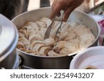 Small photo of Vegetarian traditional dumpling momos. Tibetan momo Street food in Mall road Kullu Manali Himachal Pradesh India.