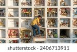 Small photo of Ica, Peru - 24 October 2023: Grave keeper working at traditional Peruvian cemetery with stacked crypts and shadowbox window, maintaining the final resting places, keeping them neat and dignified.