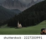 photographer taking picture of ranui church in south tyrol funes valley dolomites italy view