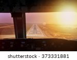 Final approach during sunset. View from flight deck of a modern airliner plane