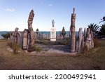 Small photo of Isle of Pines, New Caledonia - October 19 2019: Carved totem palisade commemorating the first Catholic service given here
