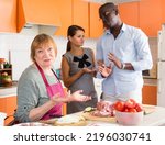 Small photo of Chagrined senior woman having problems in relationship with adult daughter and her African husband