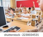 Small photo of Portrait of diligent towheaded preteen girl looking at camera during lesson in primary school