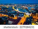 Aerial view of illuminated streets and buildings at night, Rzeszow, Poland