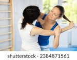 Small photo of Women in self-defense class practiced elbow strikes to incapacitate potential attackers.