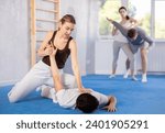 Small photo of Couples self-defense training - a woman learns to seize power against a male attacker