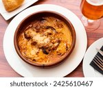 Small photo of Traditional baked Balkan moussaka with aubergines, minced meat and tomato in creamy sauce served in clay bowl..