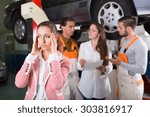 Small photo of Unhappy female duping by troubleshooters at auto service center