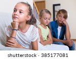 Small photo of Offended little girl is jealous sister of stepbrother at home interior
