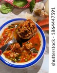 Small photo of Loaded Italian tomato meatball soup with cannellini beans spinach green peas and parmesean rind