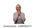 Small photo of European senior woman with gray hair showing modesty on white background