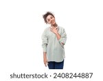Small photo of portrait of a charming sympathetic caucasian woman with black curly hair in a net shirt on a white background