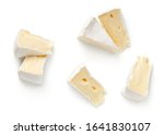 Pieces of camembert cheese isolated on white background. Flat lay. Top view