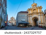 Small photo of Vilnius, Lithuania, July 7, 2022: Night view of a street leading towards The Church of St Theresa in Vilnius, Lithuania..