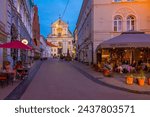Small photo of Vilnius, Lithuania, July 6, 2022: Night view of a street leading towards The Church of St Theresa in Vilnius, Lithuania..