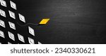 Small photo of Yellow Paper Boat Leaving Mainstream And Changing Direction On Modern Black Wooden Table - Entrepreneur Concept