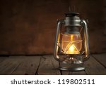 Oil Lamp At Night On A Wooden...