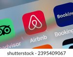 Small photo of Paris, France - November 30, 2023 : Close up of travel app photographed from a smartphone, pleasing defocus due to the inclination. Airbnb icon in focus.