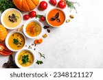 Small photo of Autumn soups. Set of various seasonal vegetable soups and organic ingredients on white background, copy space. Homemade colourful seasonal vegan soups.