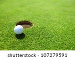 Golf Ball On Lip Of Cup