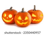 Three glowing halloween pumpkin ...